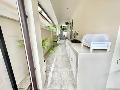 Charming outdoor kitchen with sleek countertops and lush greenery, perfect for al fresco dining and entertaining.