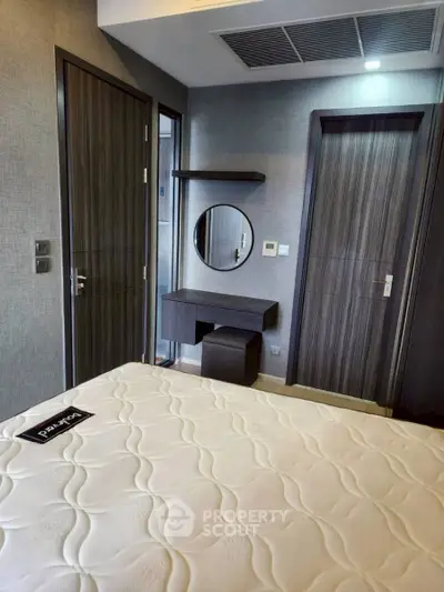 Modern bedroom with stylish decor and comfortable mattress in a contemporary apartment.