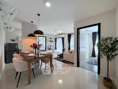Modern open-plan living and dining area with stylish decor and natural light.