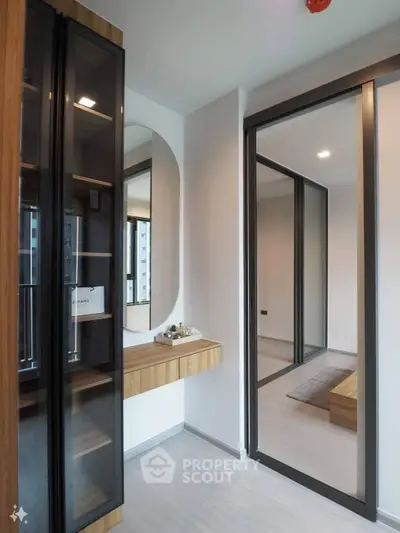 Modern apartment interior with glass doors and wooden accents