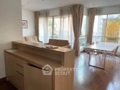 Spacious living room with modern furniture and large windows offering natural light.