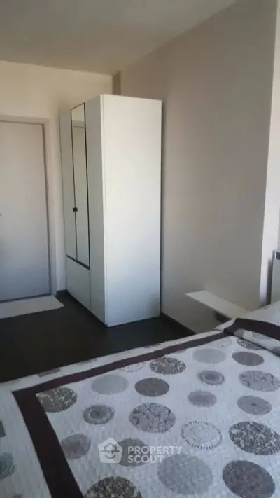 Cozy bedroom with modern wardrobe and stylish bedspread