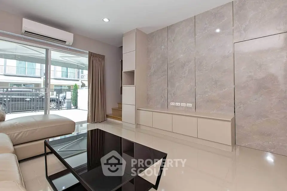 Modern living room with sleek design, large window, and stylish furniture in a contemporary home.