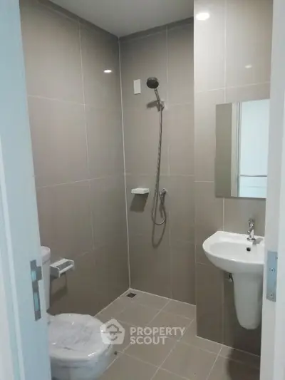 Modern bathroom with sleek tiles and minimalist fixtures in a contemporary apartment.