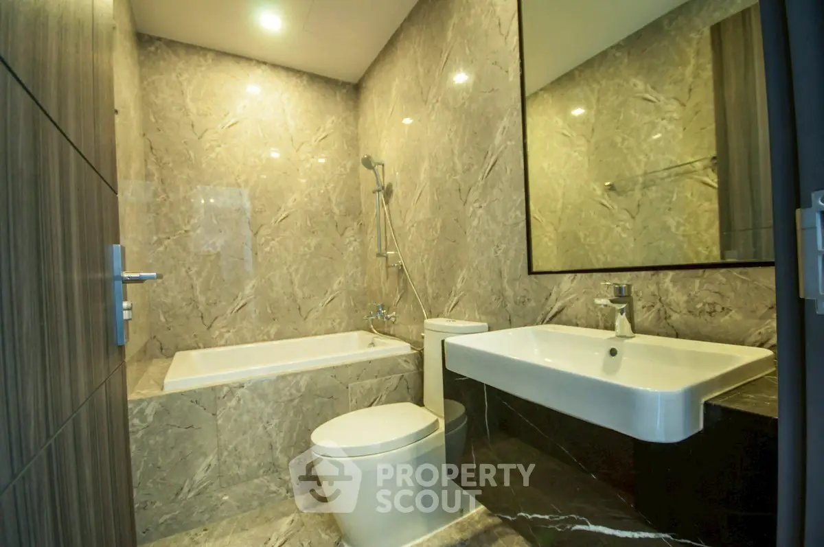 Luxurious modern bathroom with marble walls and elegant fixtures