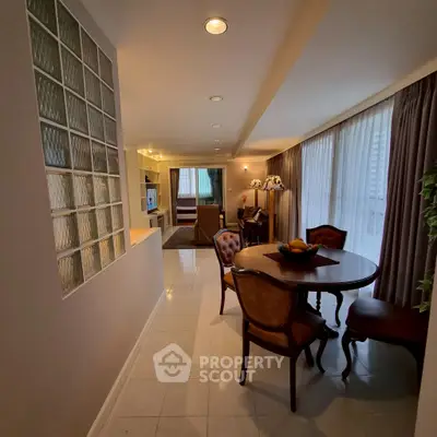 Elegant dining area with classic furniture and natural light in a cozy apartment setting.