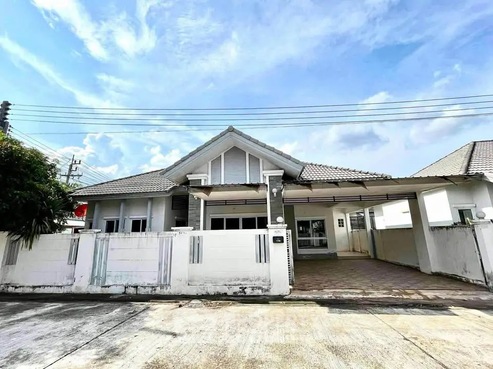 Charming single-story house with spacious driveway and modern design in a serene neighborhood.