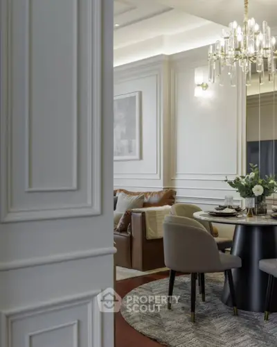 Elegant dining area with chandelier and modern decor in luxury apartment
