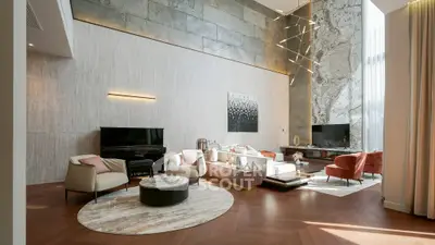 Luxurious high-ceiling living room with modern decor and elegant lighting