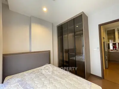 Modern bedroom with glass wardrobe and cozy lighting