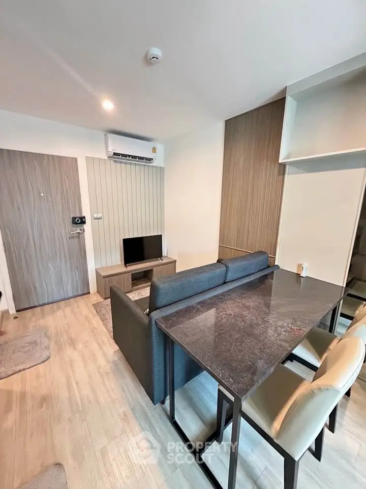 Modern living room with sleek furniture and open layout in a stylish apartment.