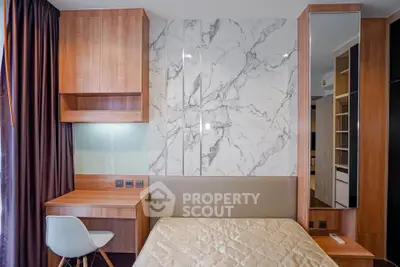 Modern bedroom with stylish wooden furniture and marble accent wall