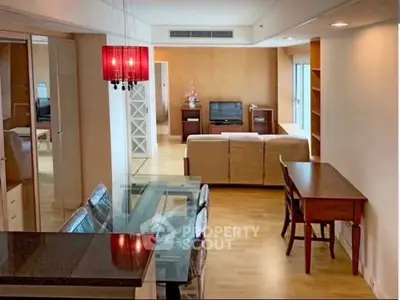 Spacious open-plan living and dining area with modern furnishings and natural light.