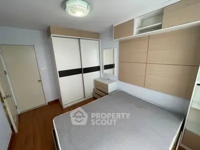 Modern bedroom with sleek wardrobe and minimalist design, perfect for urban living.