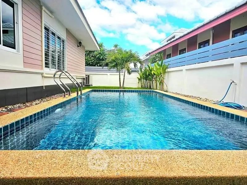 Stunning private pool with lush surroundings in a modern residential property.