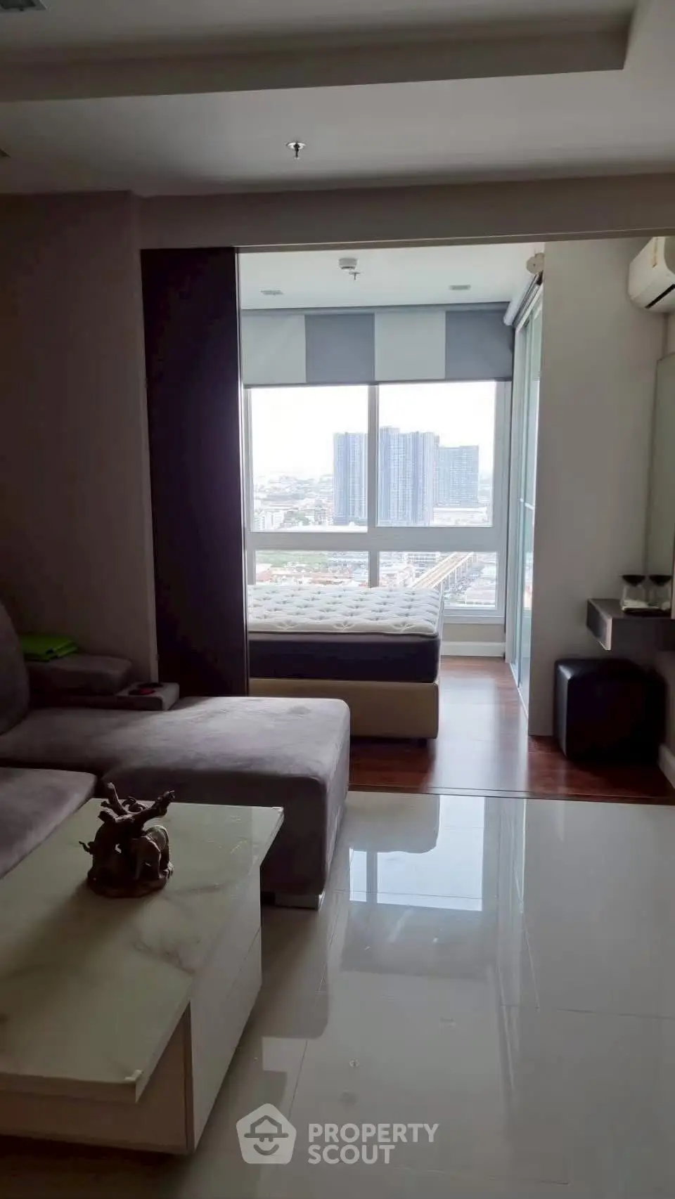 Modern living room with city view and cozy bedroom