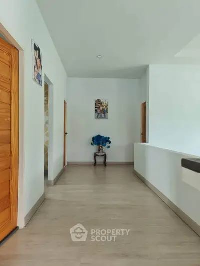 Spacious hallway with wooden doors and modern decor