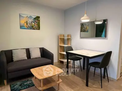 Cozy living room with modern furniture and stylish decor in a compact apartment.