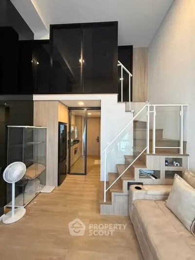 Modern loft apartment with stylish staircase and cozy living area