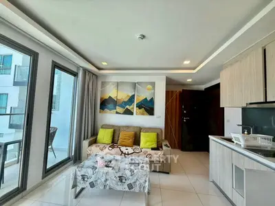 Modern living room with balcony access and stylish decor in a contemporary apartment.