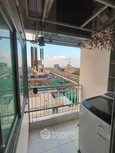 Charming balcony with city view and laundry area, perfect for urban living.