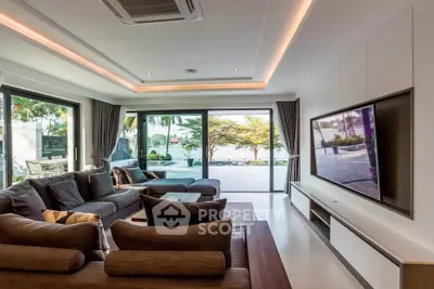 Luxurious living room with modern decor and stunning poolside view