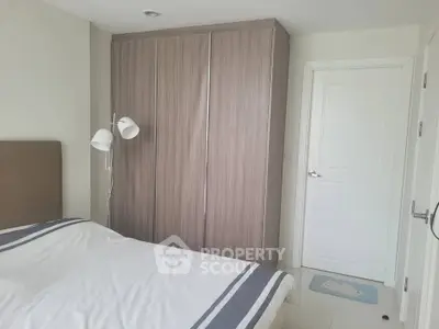 Modern bedroom with sleek wardrobe and cozy bed in a stylish apartment.