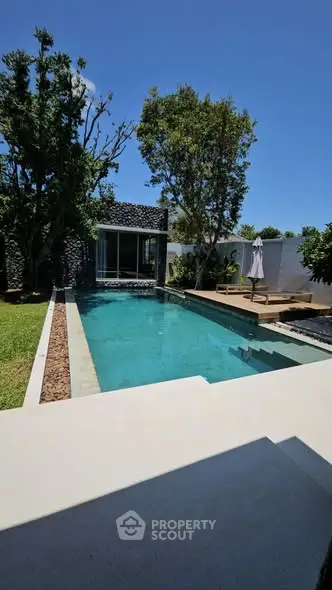 Luxurious modern villa with private pool and lush garden, perfect for relaxation and entertainment.