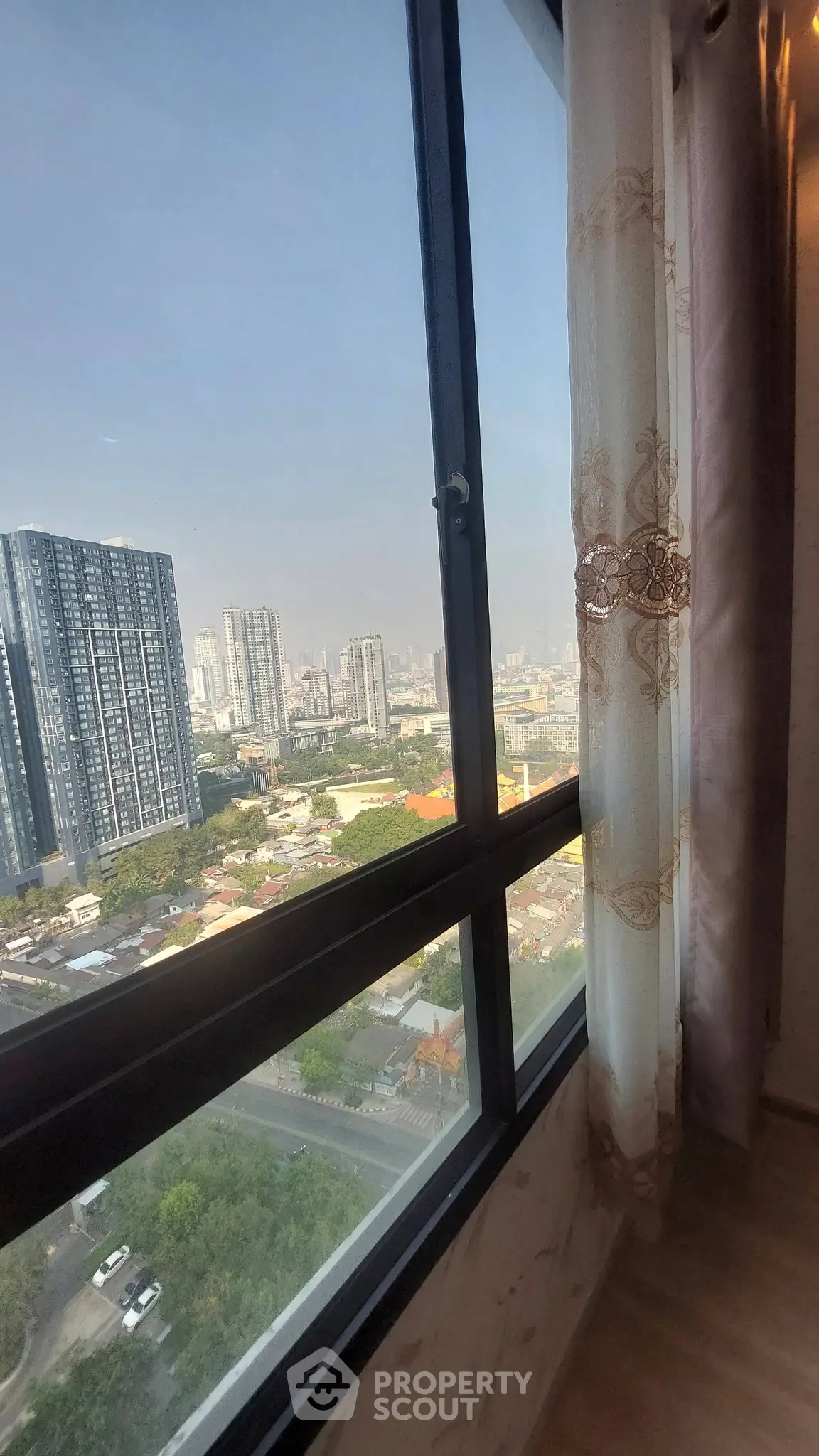 Stunning high-rise city view from a modern apartment window, perfect for urban living.