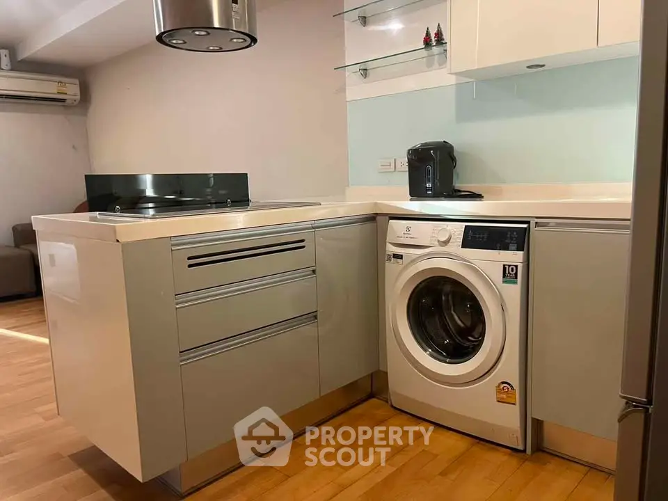 Modern kitchen with integrated washing machine and sleek cabinetry