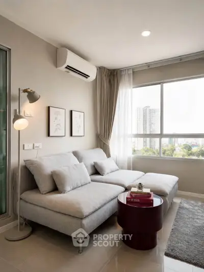 Modern living room with large window and city view, featuring stylish furniture and elegant decor.