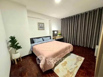 Spacious bedroom with elegant decor and cozy ambiance in modern apartment.