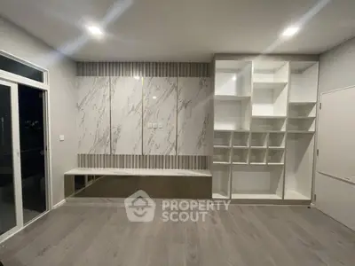 Modern living room with built-in storage and elegant marble accents