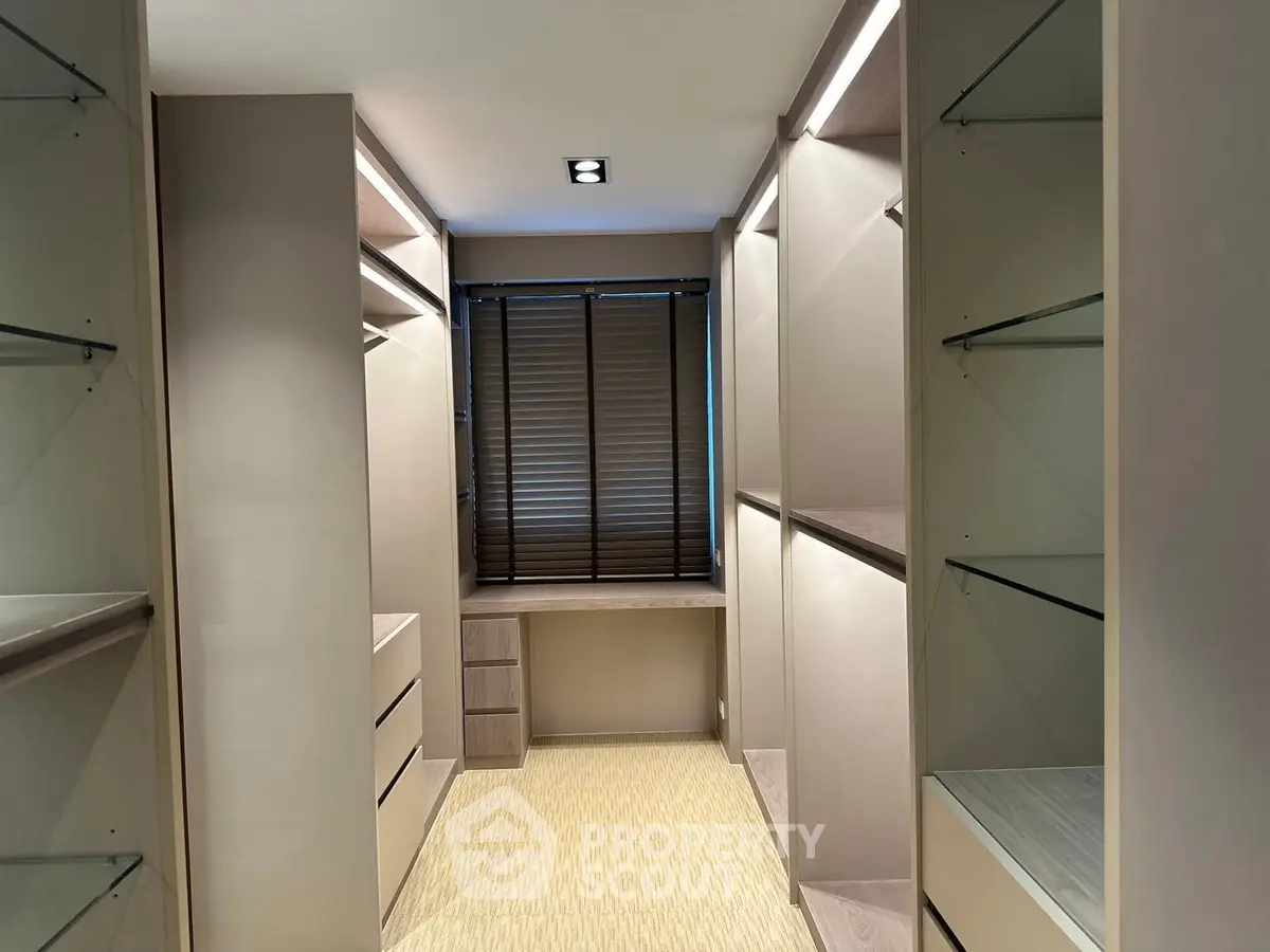 Luxurious walk-in closet with ample shelving and natural light