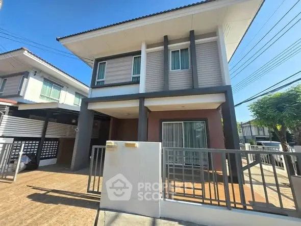 Modern two-story house with spacious driveway and stylish facade in a sunny neighborhood.