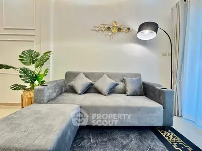 Modern living room with stylish gray sofa and elegant decor