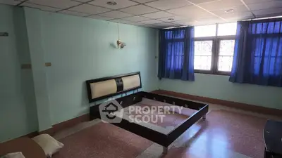 Spacious bedroom with large window and minimalist bed frame, ideal for customization.