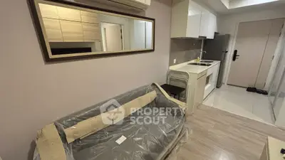 Modern compact apartment with sleek kitchen and cozy living area, perfect for urban living.