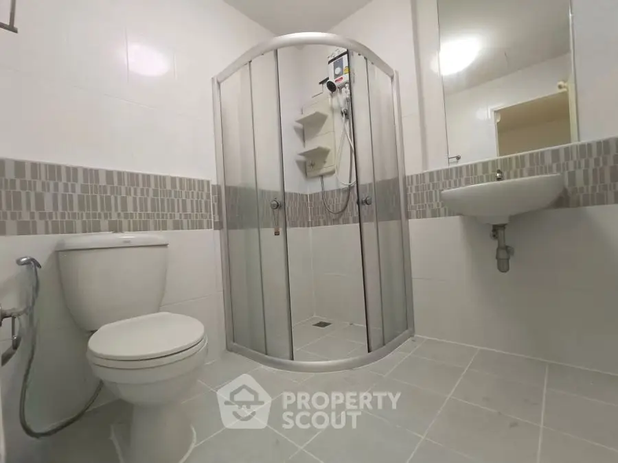 Modern bathroom with shower enclosure and sleek fixtures