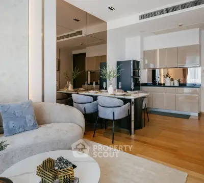 Luxurious open-plan living room and kitchen with modern decor and elegant dining area.
