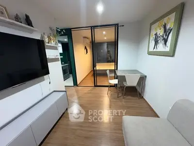 Modern living room with sleek TV setup and stylish dining area