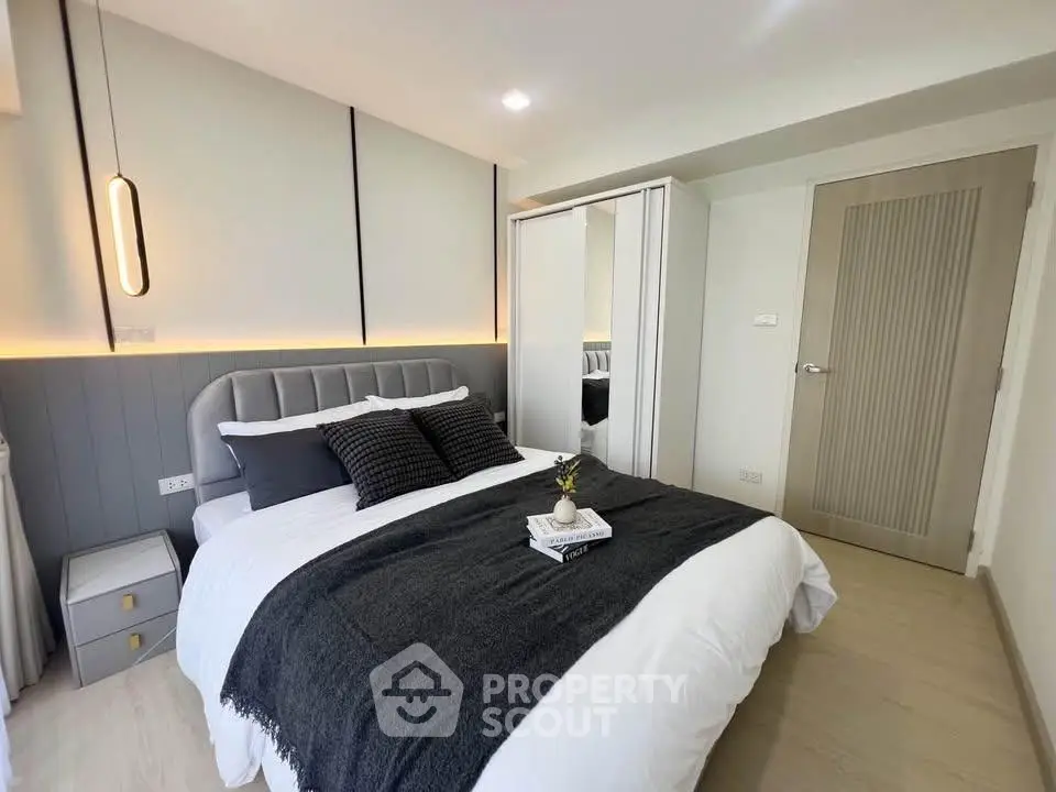 Modern bedroom with stylish decor and cozy ambiance, featuring a comfortable bed and sleek furnishings.