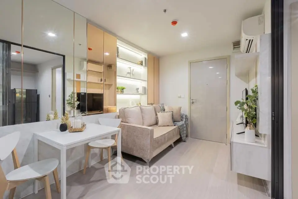 Modern living room with cozy sofa and dining area, featuring stylish decor and bright lighting.