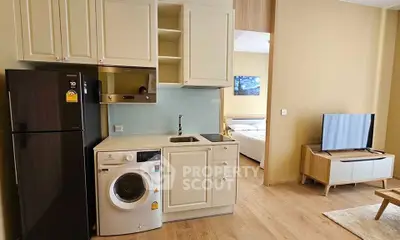 Modern compact kitchen with washing machine and fridge in cozy apartment