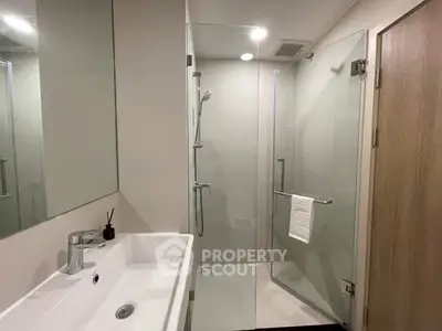 Modern bathroom with glass shower and sleek sink design