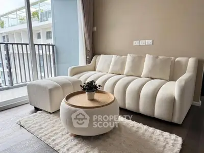 Modern living room with elegant white sofa and balcony view in luxury apartment