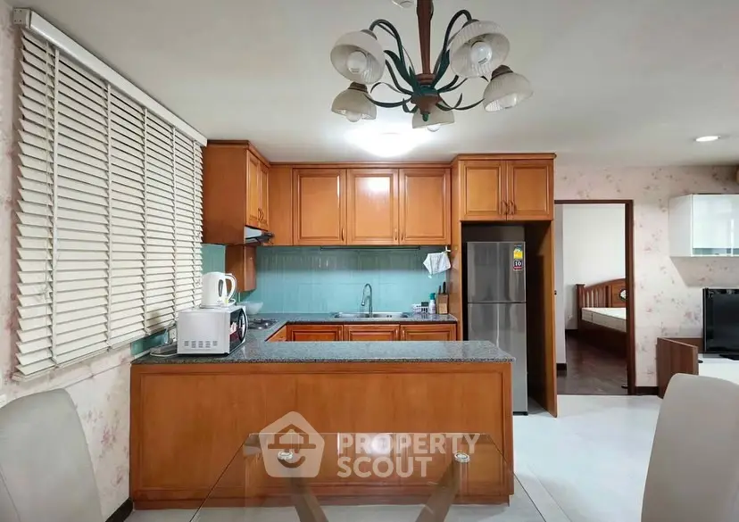 Charming kitchen with wooden cabinets and modern appliances in cozy home setting.