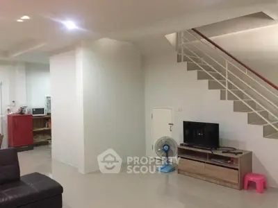 Modern living room with sleek staircase and minimalist decor