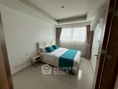 Modern bedroom with elegant decor and natural light, featuring a cozy bed and stylish curtains.