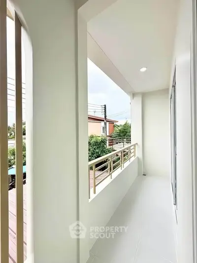 Spacious balcony with modern railing and serene view, perfect for relaxation.